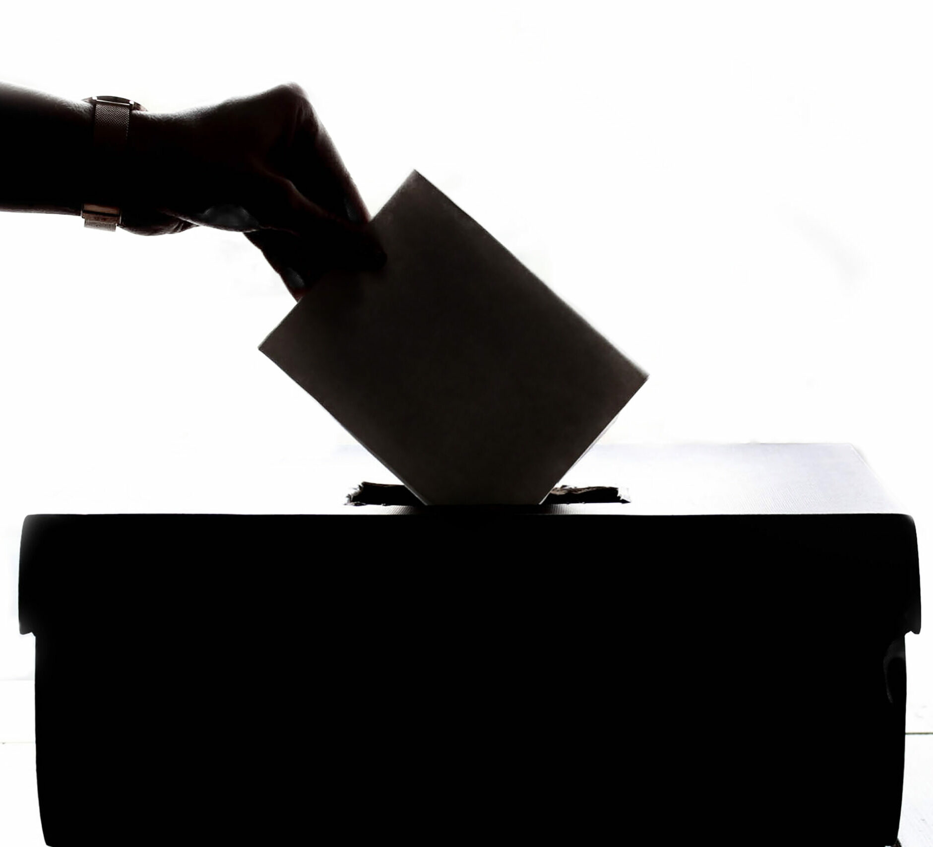 Person dropping paper on box