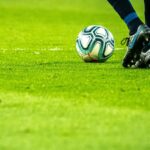 man playing soccer game on field