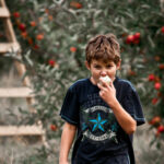 Photo of boy eating an apple
