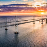 Aerial panorama of Chesapeake Bay Bridge at sunset. The Chesapeake Bay Bridge (known locally as the Bay Bridge) is a major dual-span bridge in the U.S. state of Maryland.