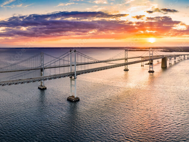 Aerial panorama of Chesapeake Bay Bridge at sunset. The Chesapeake Bay Bridge (known locally as the Bay Bridge) is a major dual-span bridge in the U.S. state of Maryland.