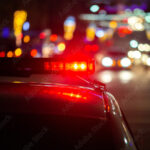 police car lights in night city with selective focus and bokeh