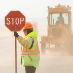 A flagger controls traffic on a Montana highway rebuild project.