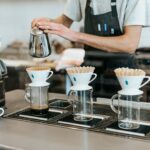 man pouring on cup