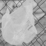 white plastic bag on chain link fence