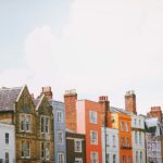 assorted-color concrete houses under white clouds during daytime