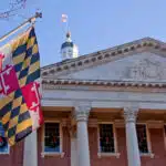 Close up view of Maryland state flag in front of the capitol state house in Annapolis, MD.