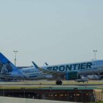 green and white Frontier airliner