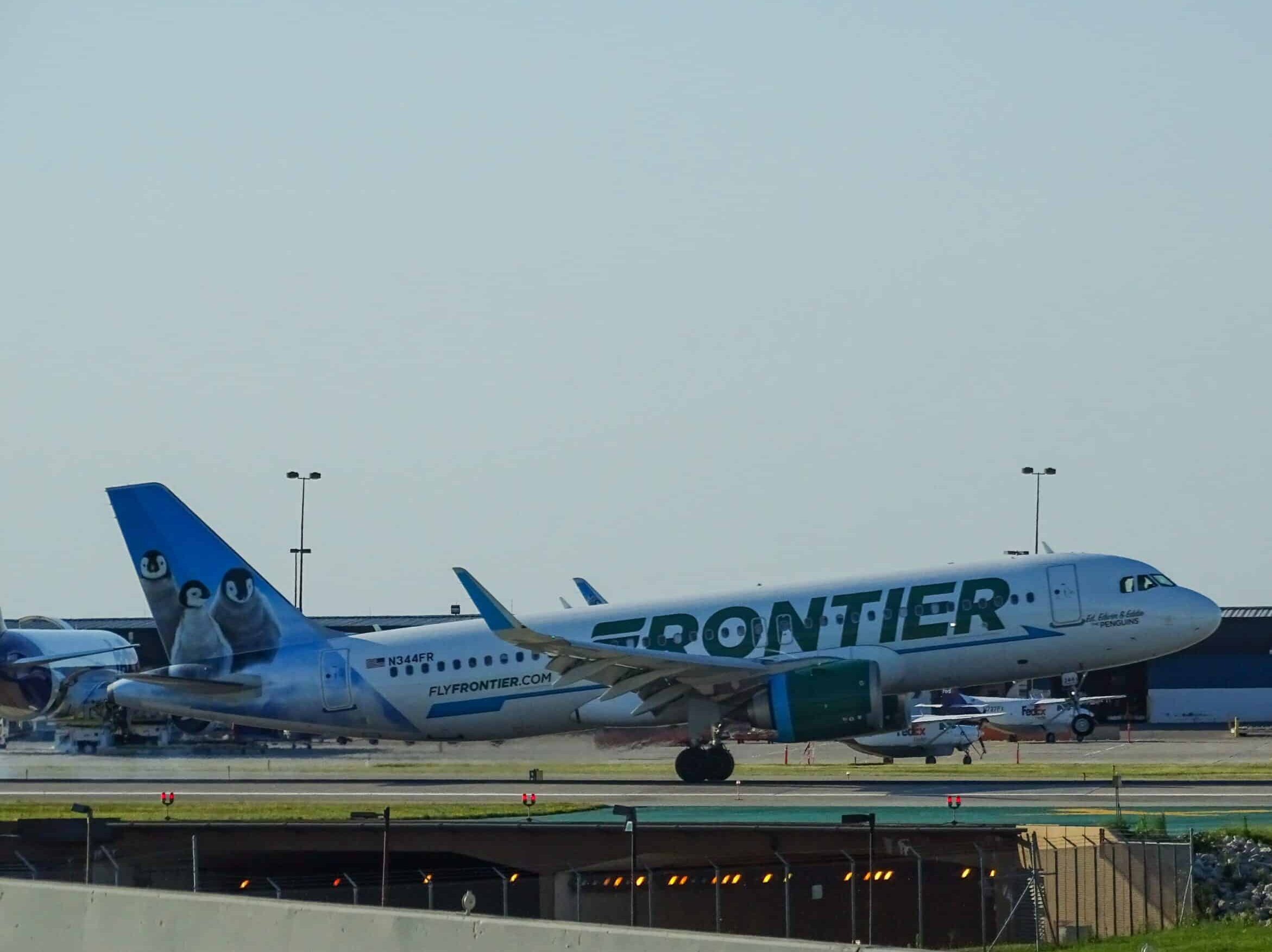 green and white Frontier airliner