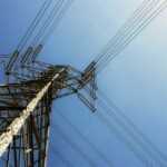 black electric post under blue sky during daytime