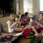 children sitting on chair eating