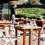 Waiter setting tables out in the sun in Italy