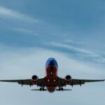 blue and red airplane on sky