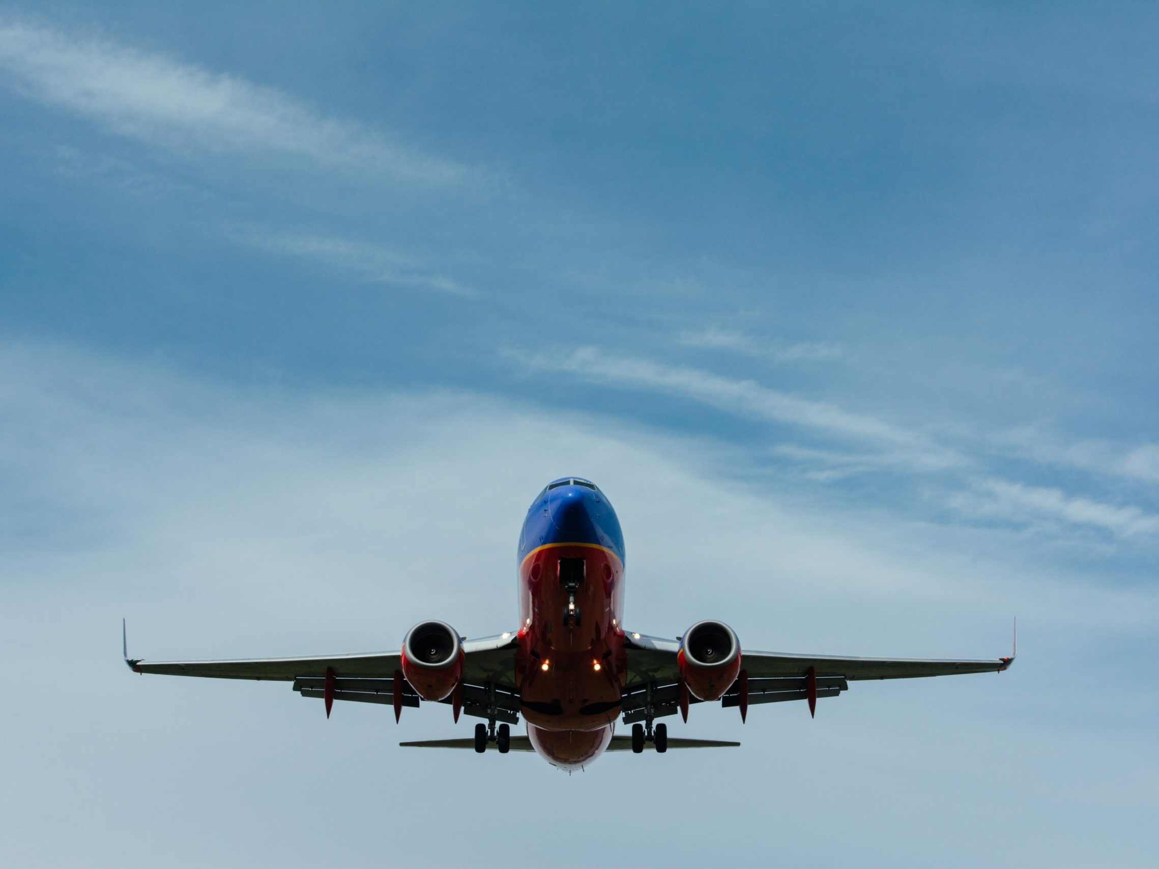 blue and red airplane on sky