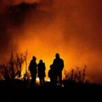 Family watching a wildfire in the distance in the summer of 2020.