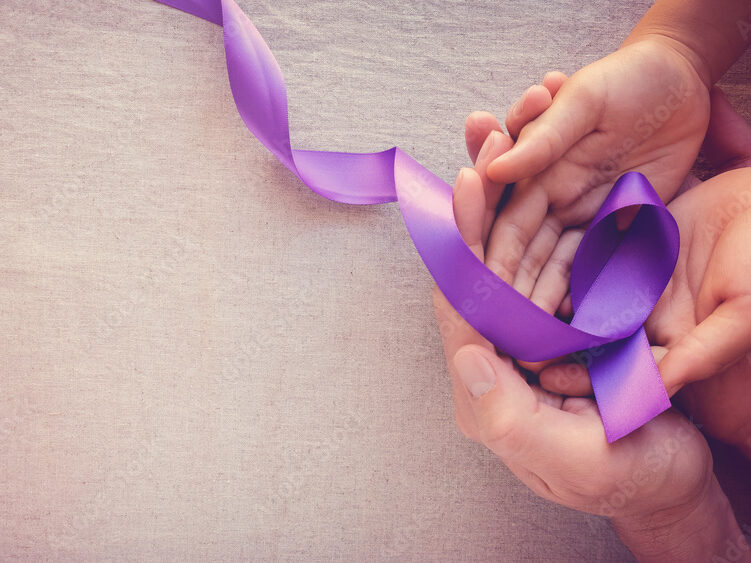 Hands holding Purple ribbons, toning copy space background, Alzheimer disease, Pancreatic cancer, Epilepsy awareness, domestic violence awareness