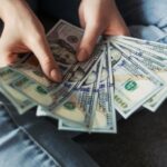 Girl holding American Dollar Bills