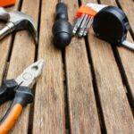 assorted-type carpentry tools on brown surface