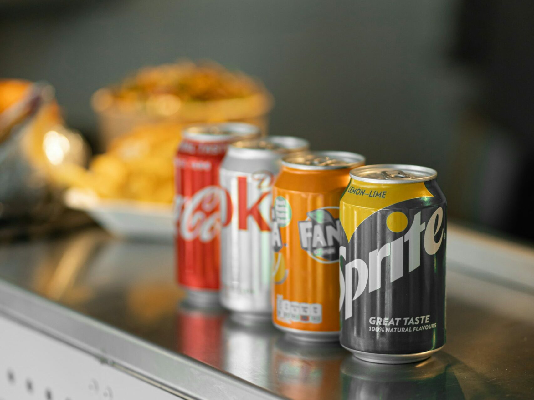 two coca cola cans on stainless steel table