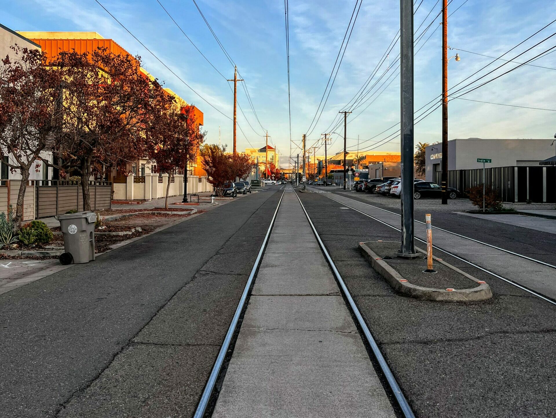 train tracks with power lines above them