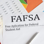 FAFSA inscription on the documents. Business concept