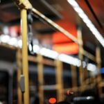 Lagos, Nigeria - 30.11.2021: Shots of the interiors, Close up of hand holding a handgrip, and a watch your step sign on a BRT, a mass transit system in Lagos, Nigeria.