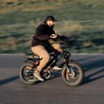 Male model riding ebike during golden hour sunset in the mountains.