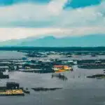 houses surrounded with water under cloudy sky