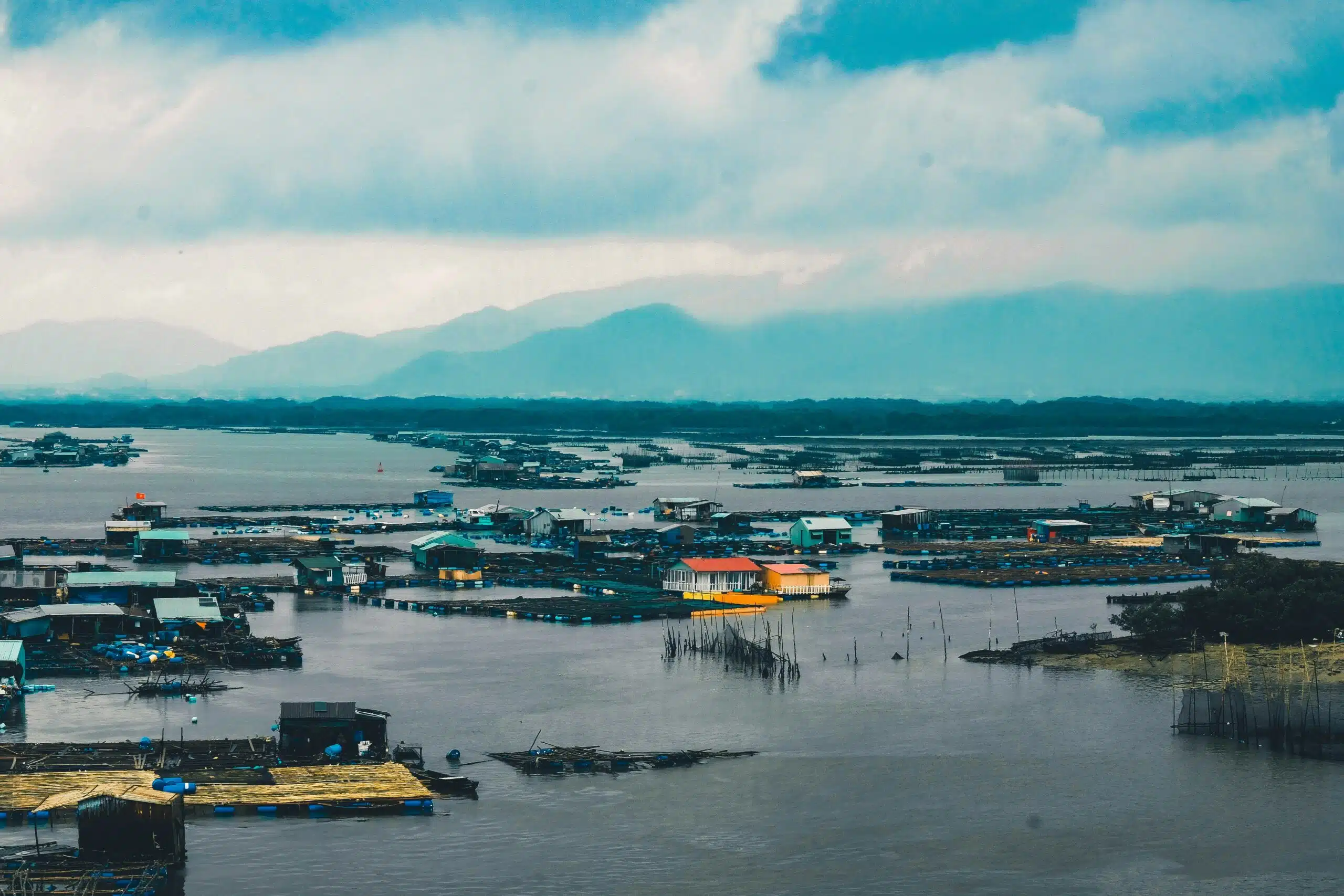 houses surrounded with water under cloudy sky