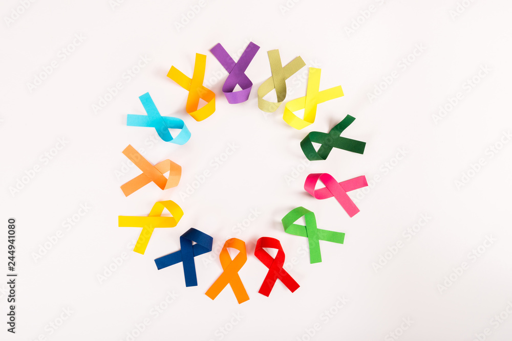 top view of colorful ribbons arranged in circle isolated on white, world cancer day concept